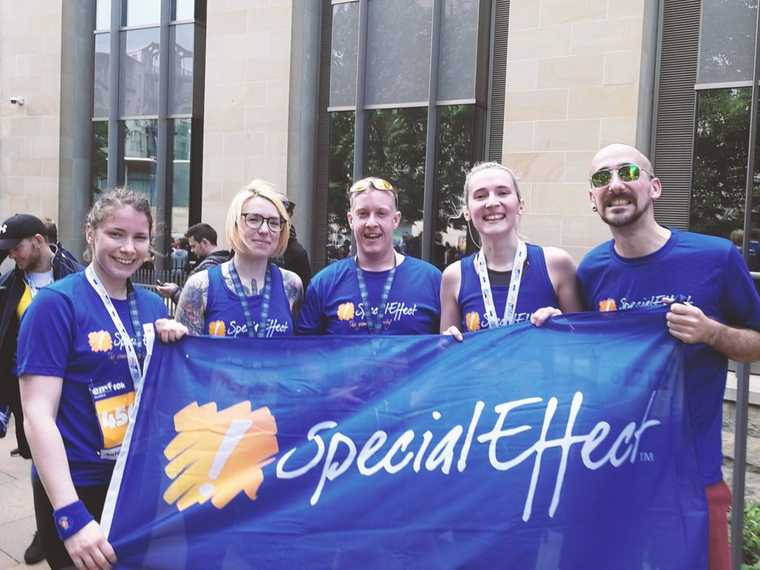 A photograph of 4 runners before their race starts.