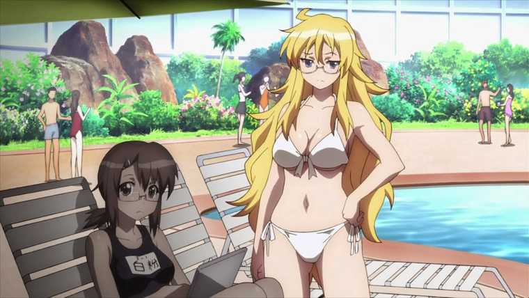 Two young women wearing swimsuits at an indoor beach