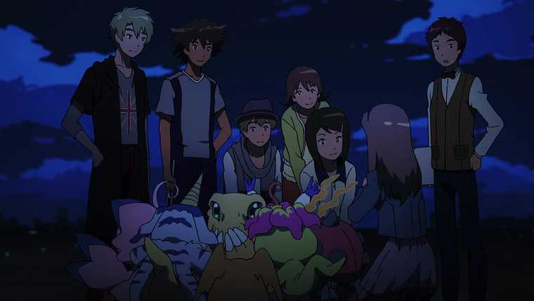 Six fashionably dressed young people are gathered outside at night.